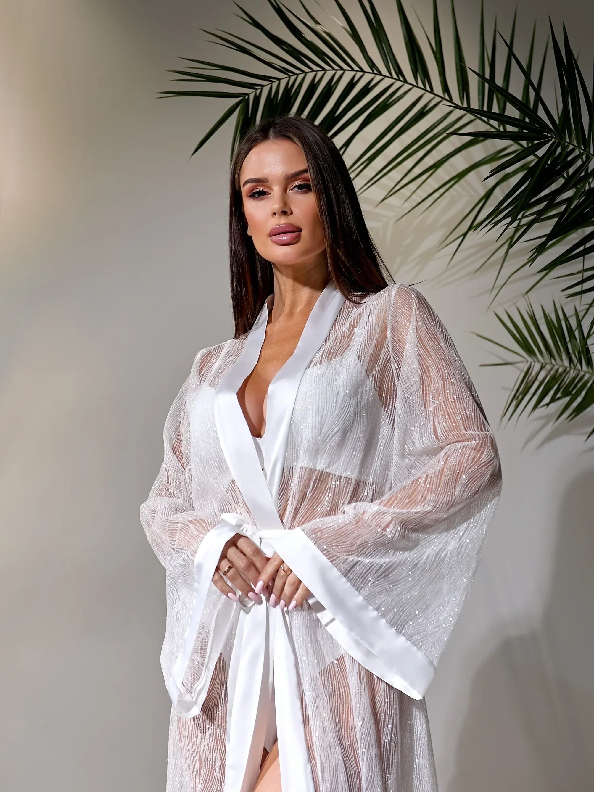 Bride in sheer white lace bridal robe with satin trim, perfect for wedding morning