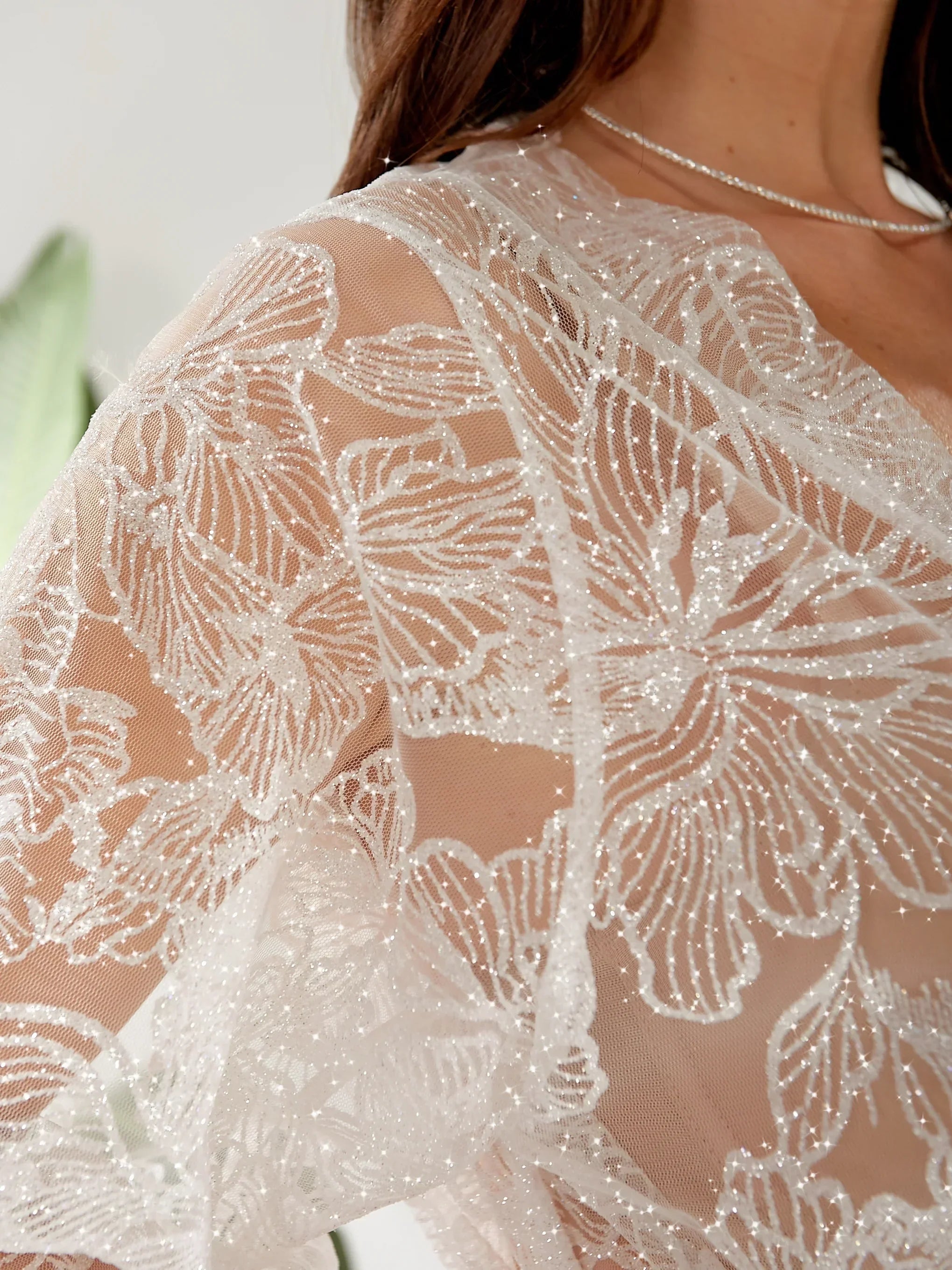 Sheer bridal robe with white floral lace details, perfect for wedding morning elegance.
