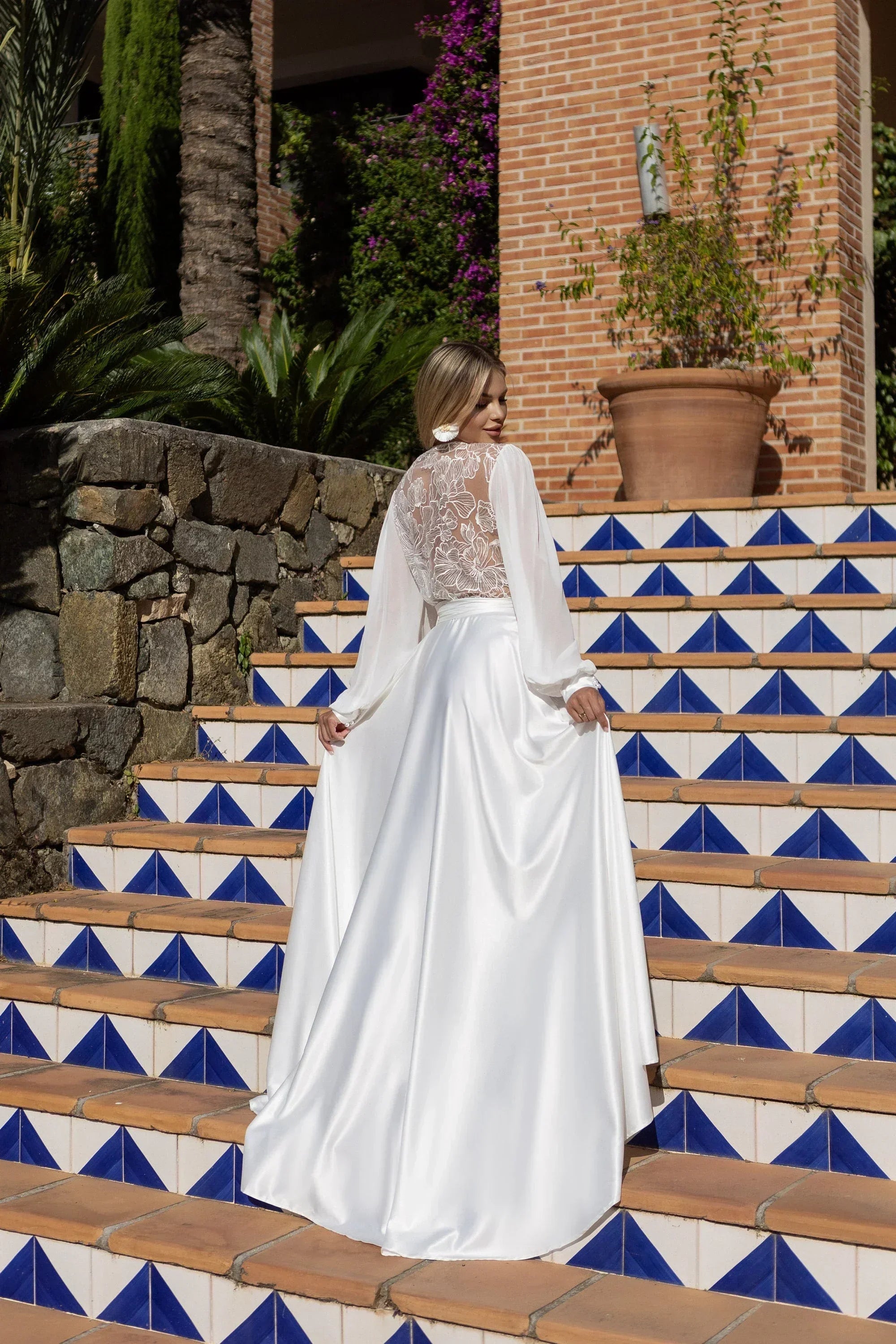 Bride in white silk bridal robe with sheer lace back, perfect for wedding morning photos.