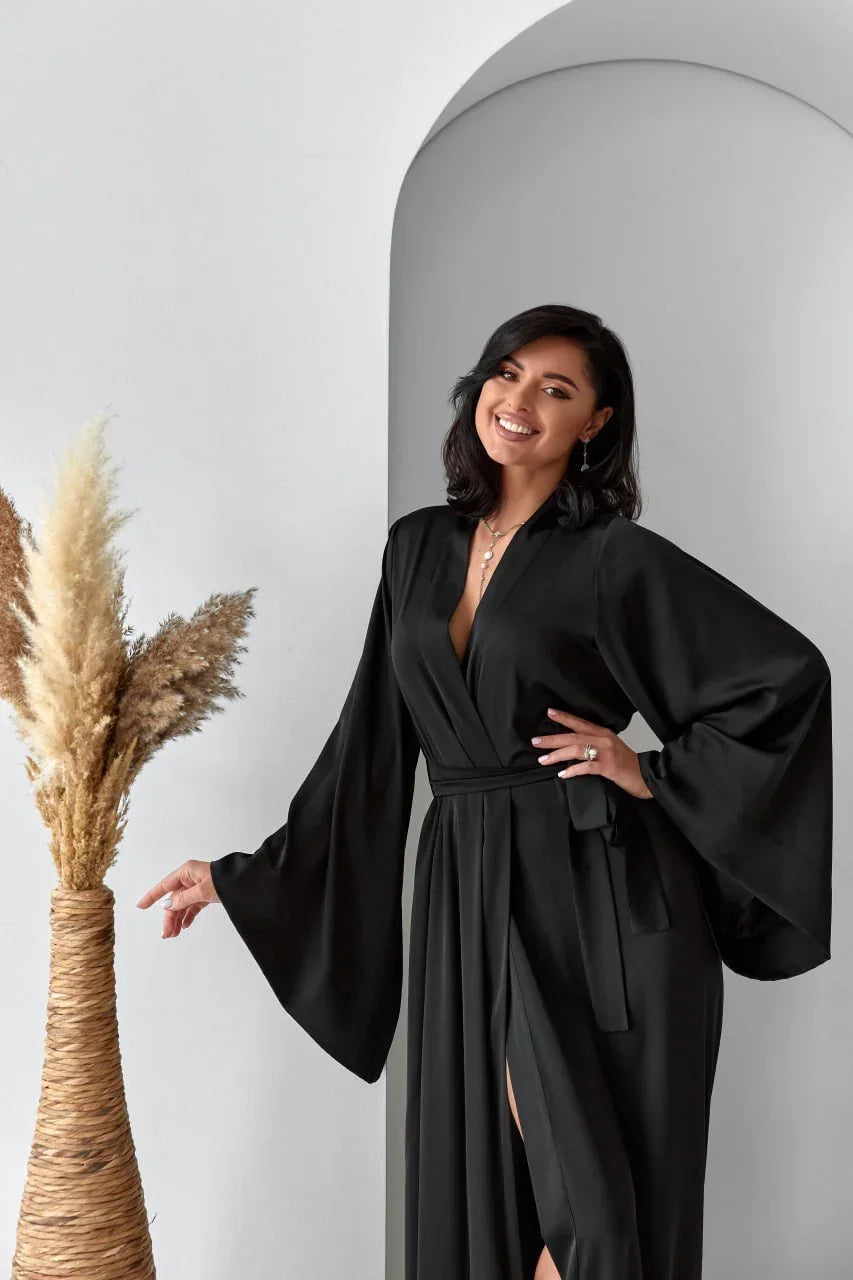 Woman in black silk bridal robe with flared sleeves, perfect for wedding morning