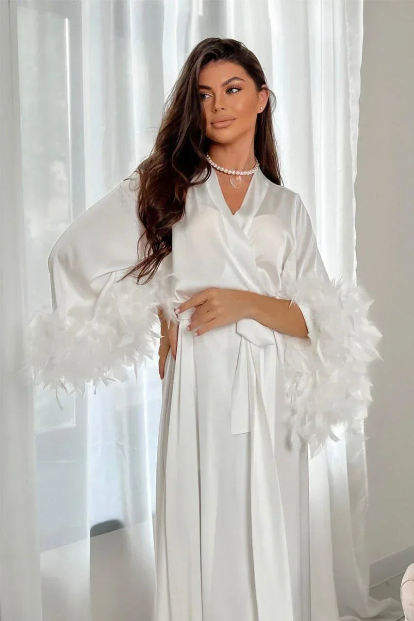 White silk bridal robe with feather-trimmed sleeves, perfect for wedding morning photos.