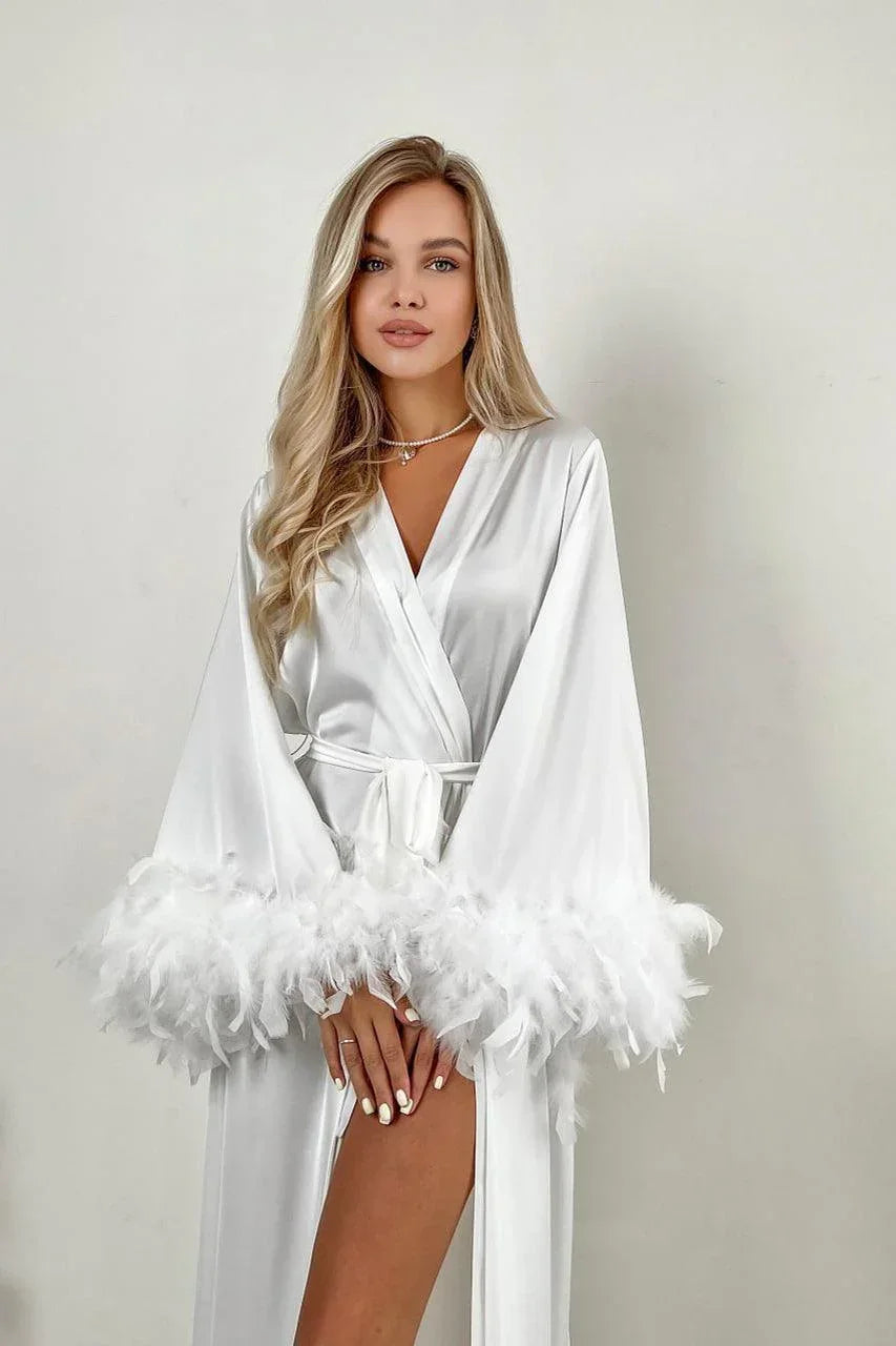 White silk bridal robe with feather-trimmed sleeves, perfect for wedding morning photos.