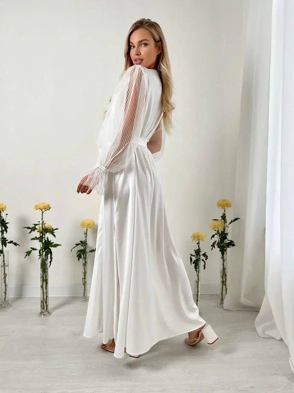 Long white silk bridal robe with sheer lace sleeves, perfect for wedding morning prep.