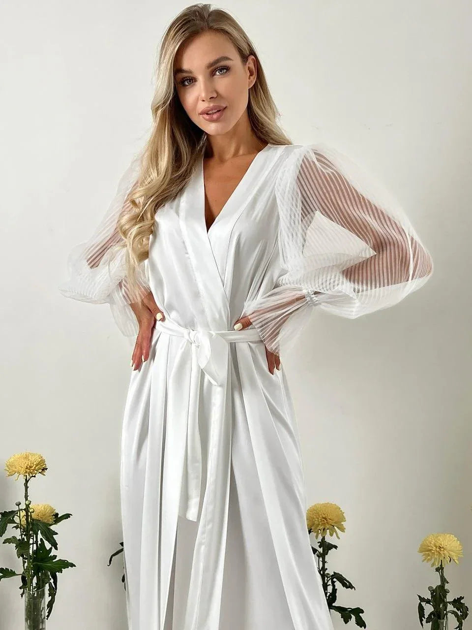 White silk bridal robe with sheer lace sleeves, perfect for wedding morning photography.