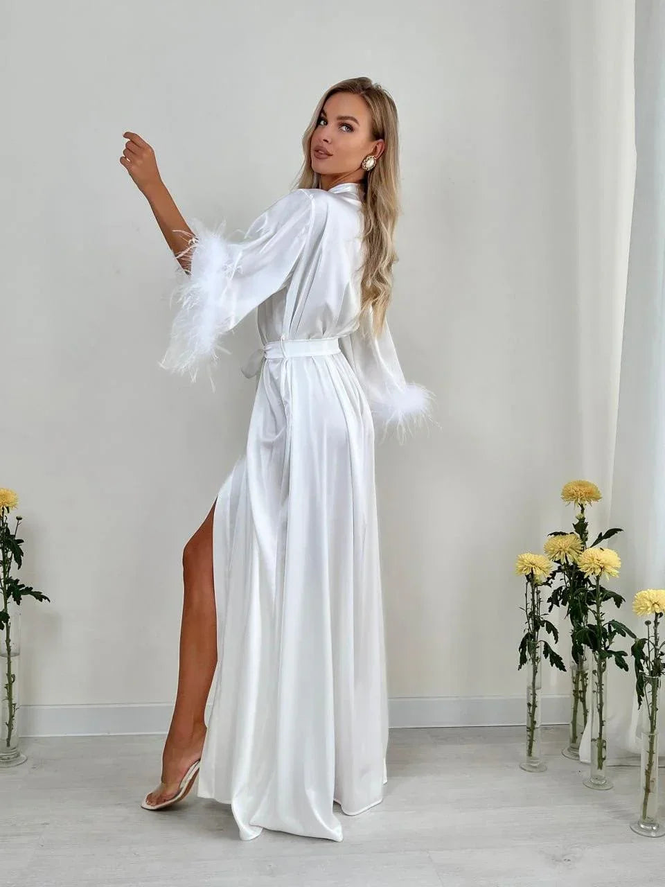 White silk bridal robe with feather cuffs, perfect for wedding morning, shown in elegant setting