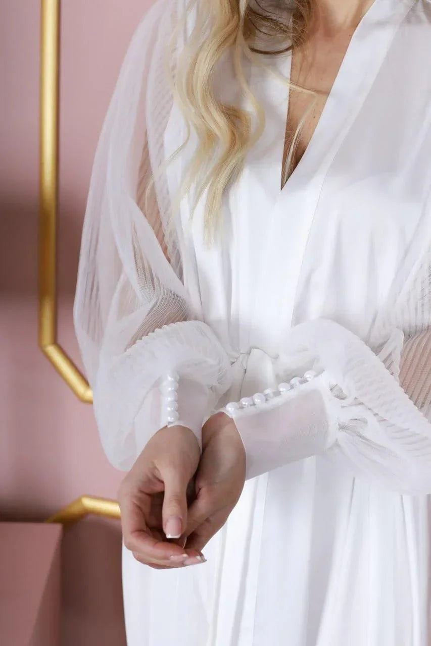White silk bridal robe with sheer lace sleeves and pearl button cuffs for wedding morning